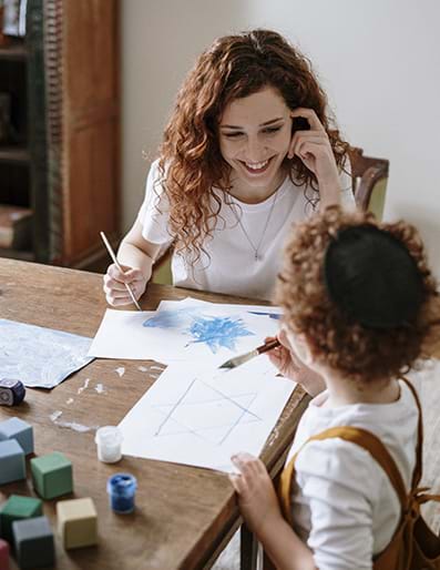 Mother interacting with Child at table